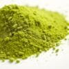 A close-up shot of a mound of vibrant, powdery barley green supplement on a clean, white backdrop. The powder appears soft and fine-grained, with a subtly luminous sheen that catches the soft, diffused lighting from above. The image conveys a sense of purity, freshness, and the natural goodness of this superfood ingredient. The overall mood is calm, crisp, and inviting, showcasing the premium quality of this Malaysian barley green powder.