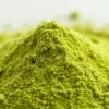 A vibrant, close-up photograph of a mound of barley green powder, meticulously captured with a macro lens. The powder appears lush and velvety, with an inviting, vivid green hue that evokes the verdant, nutrient-rich essence of the barley plant. The lighting is soft and diffused, accentuating the powder's natural luminescence and highlighting its fine, powdery texture. The composition places the powder at the center, filling the frame and drawing the viewer's eye to its soothing, earthy tones. The overall mood is one of natural health and wellness, reflecting the restorative properties of this versatile superfood.