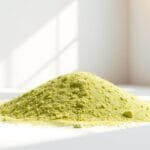 Barley grass powder, a vibrant green hue, lies in soft piles against a clean, minimalist background. Sunlight filters through a large window, casting warm, natural illumination and gentle shadows across the powdery texture. The composition is simple yet elegant, focusing the viewer's attention on the distinct color and fine-grained consistency of the barley grass. A sense of purity, health, and organic vitality emanates from the scene, inviting the viewer to imagine the nourishing properties of this superfood ingredient. The overall mood is calm, serene, and evocative of a wellness-focused lifestyle.